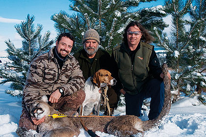 bowhunters and dog with harvested mountain lion