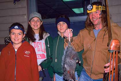 John Roseland and the Bentler girls after a nighttime possum hunt.
